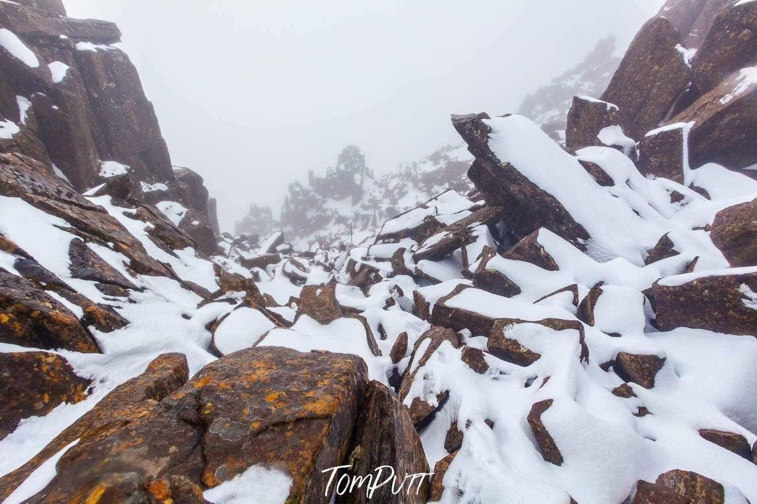 A morning view of a Stoney hill area with small rock pieces covered with the fresh snow, Cradle Summit - Cradle Mountain TAS