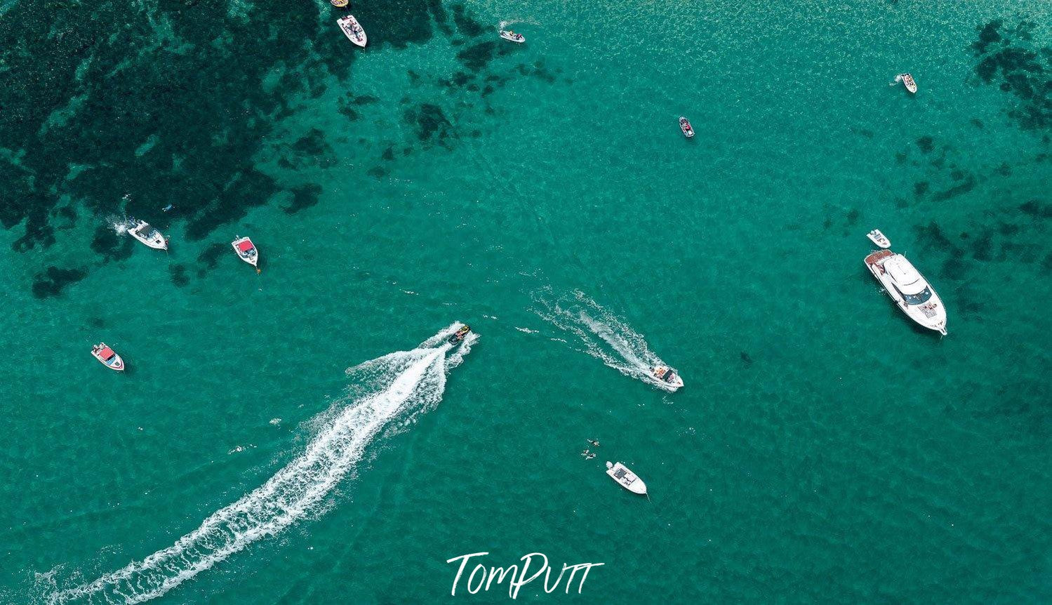 An aerial view of a deep sea-green ocean with some boats floating on different directions and with different speed, Crossover, Portsea - Mornington Peninsula VIC