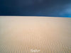 A large desert area with the natural line prints on it and a dark black sky in the far background, Desert Darkness - Kangaroo Island SA