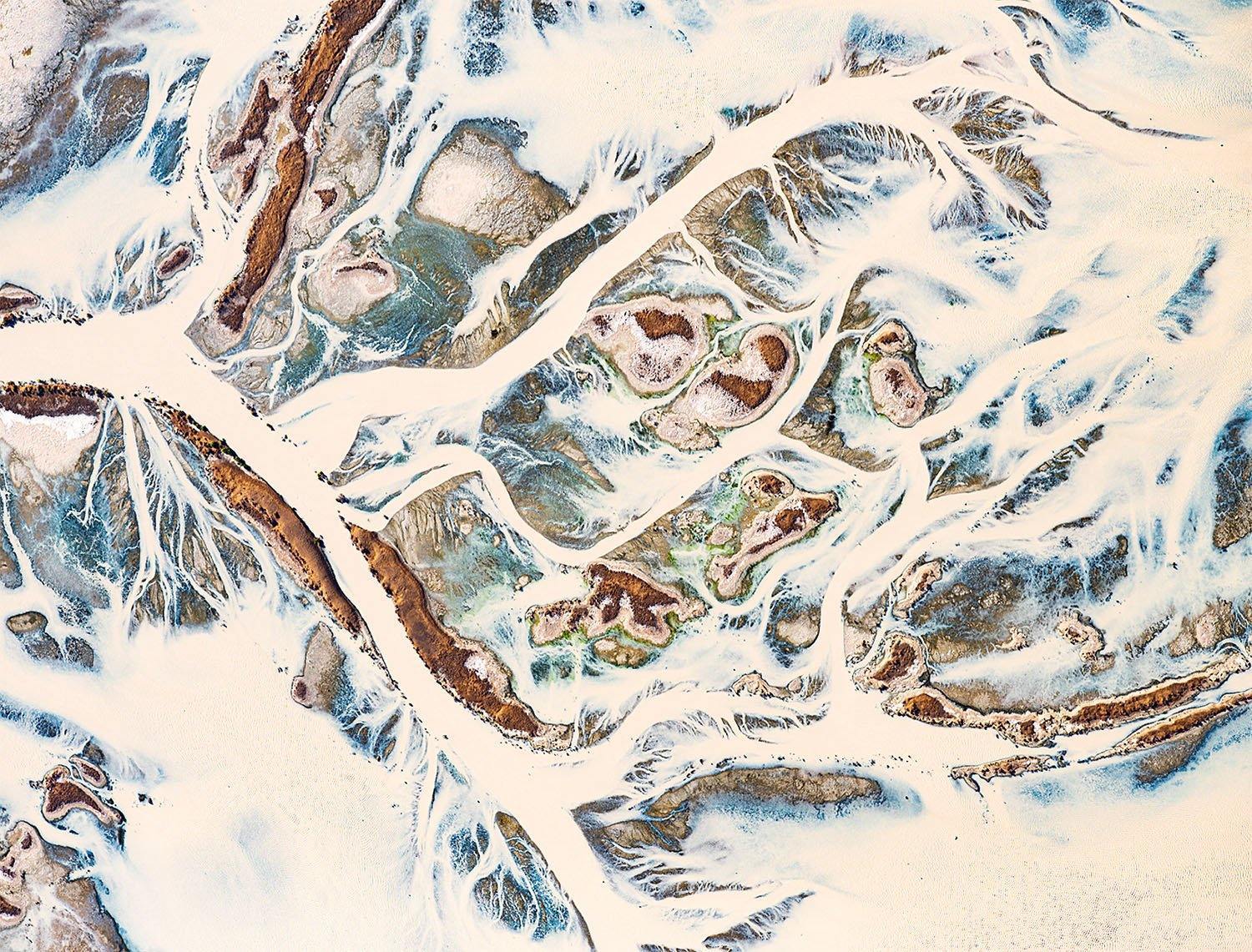 A snow desert with a lot of unclear curves and lines, forming a little green and brown colors on the shapes, Desert Rains