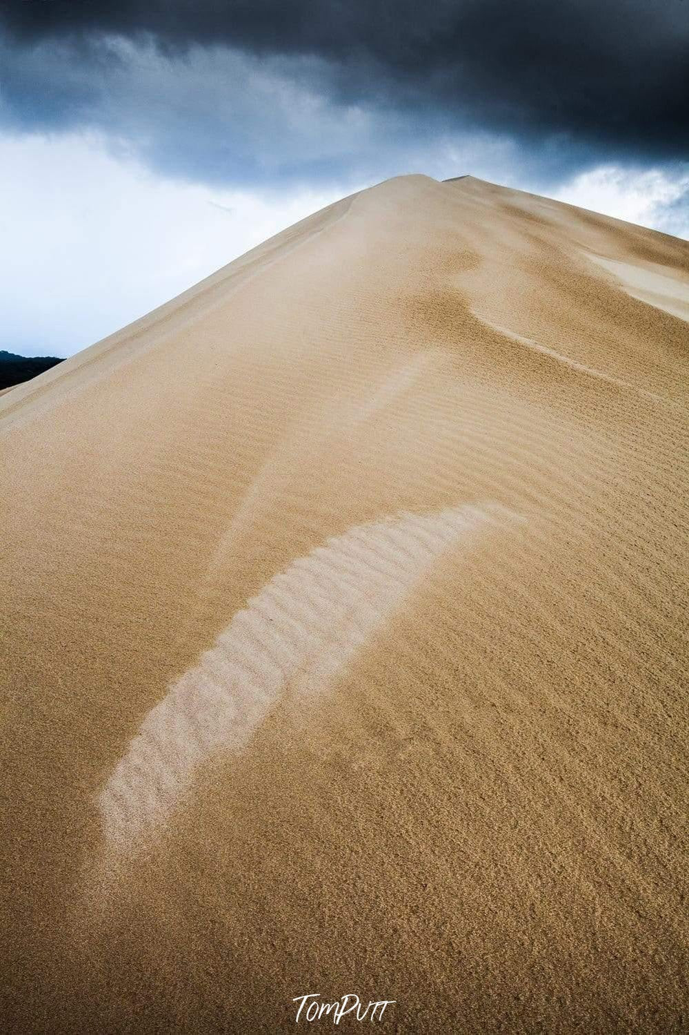 A giant mountain of sand in the desert with heavy black clouds in the background, Dune Dampness - Kangaroo Island SA