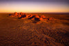 A shiny effect of sunlight on desert land with a group of small sand mounds and nothing else in the entire picture, Early Light, Kata Tjuta - Red Centre NT