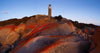 Lighthouse on the hill point of mountains, a lot of big red stones in the foreground, and a clear shiny weather, Eddystone Point Lighthouse, Bay of Fires