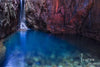 A crytsal blue water lake under the mountain walls, a little waterfall on the front corner, El Questro Waterfall - The Kimberley WA