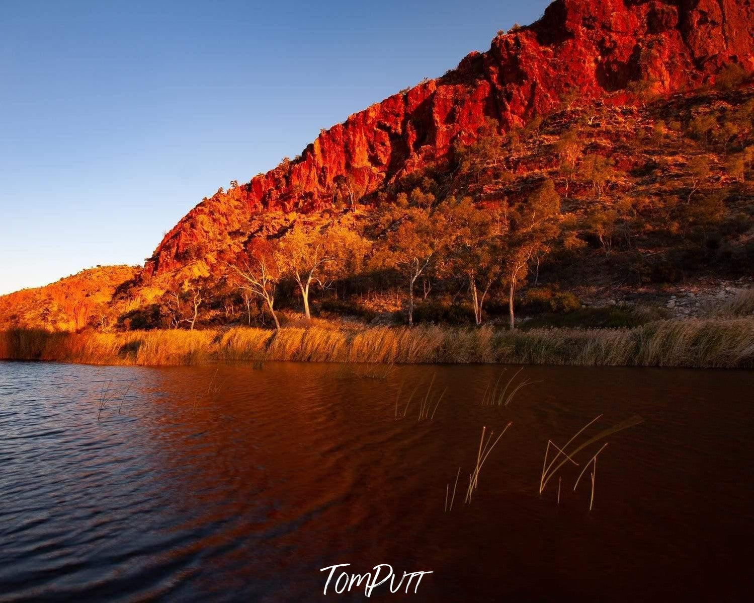 A long mountain with a lake in the foreground, Finke River - West Macdonnell Ranges, NT