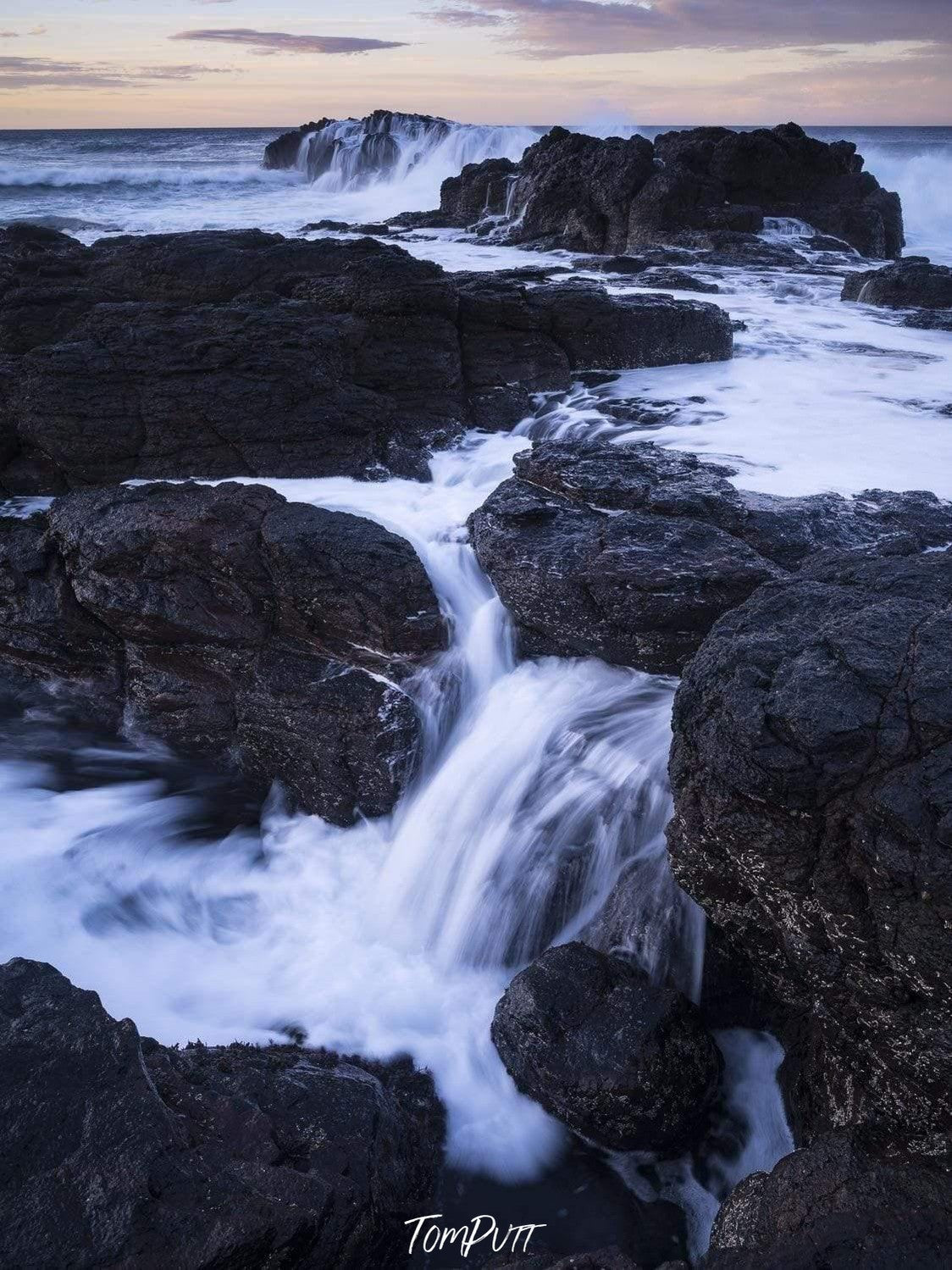 Giant black stones in the sea with steady water flow, Flinders Blowhole - Mornington Peninsula VIC