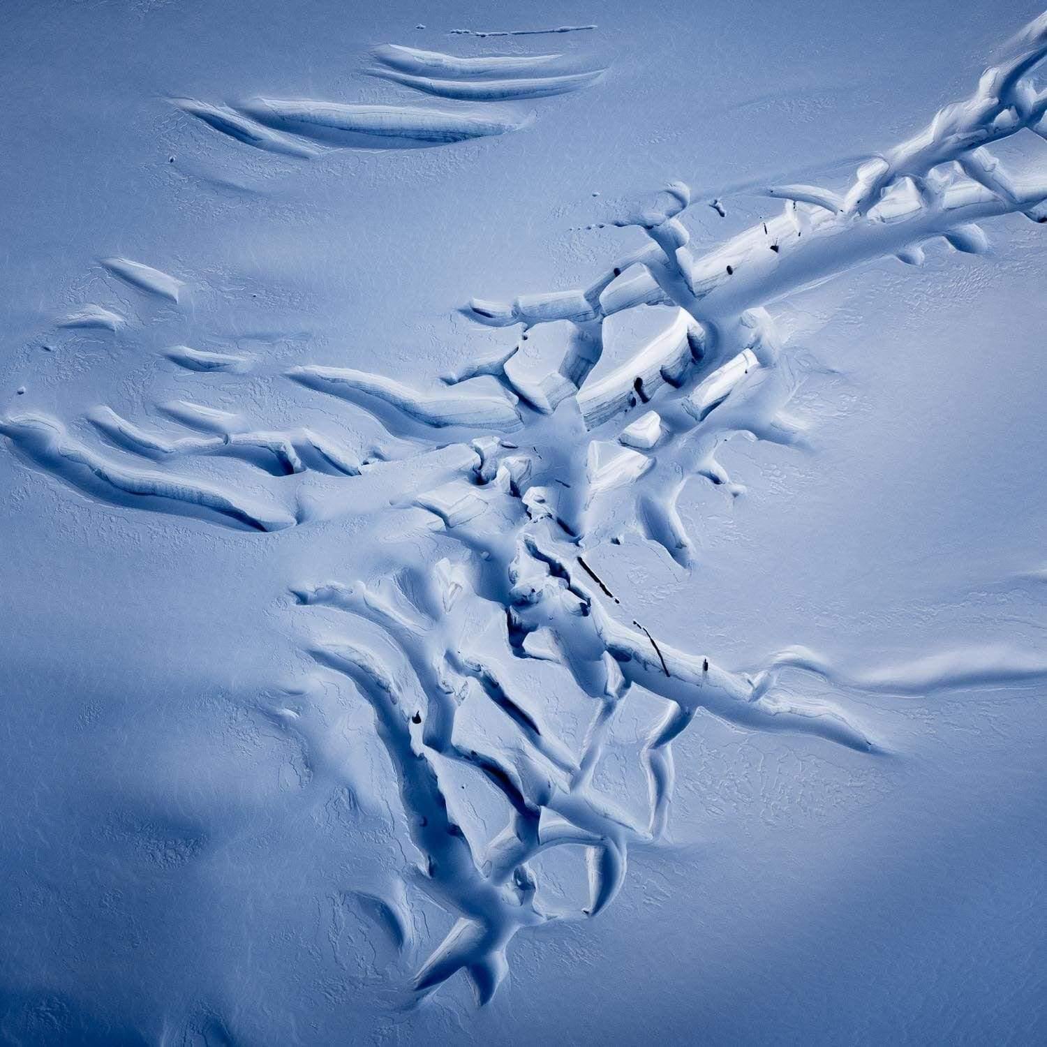 Long curvy cracking view on a wet snow ground, Fractured