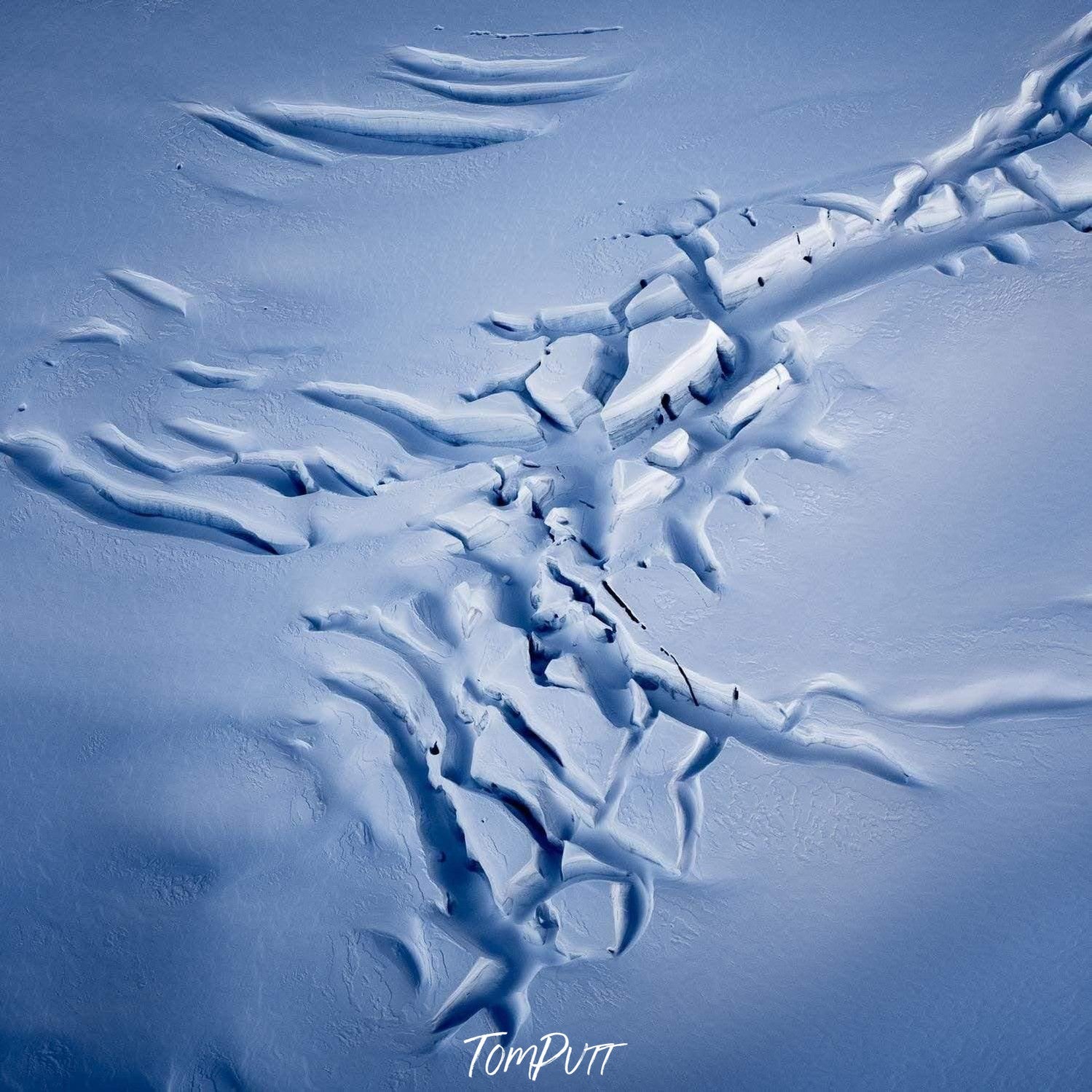 Long curvy cracking view on a wet snow ground, Fractured