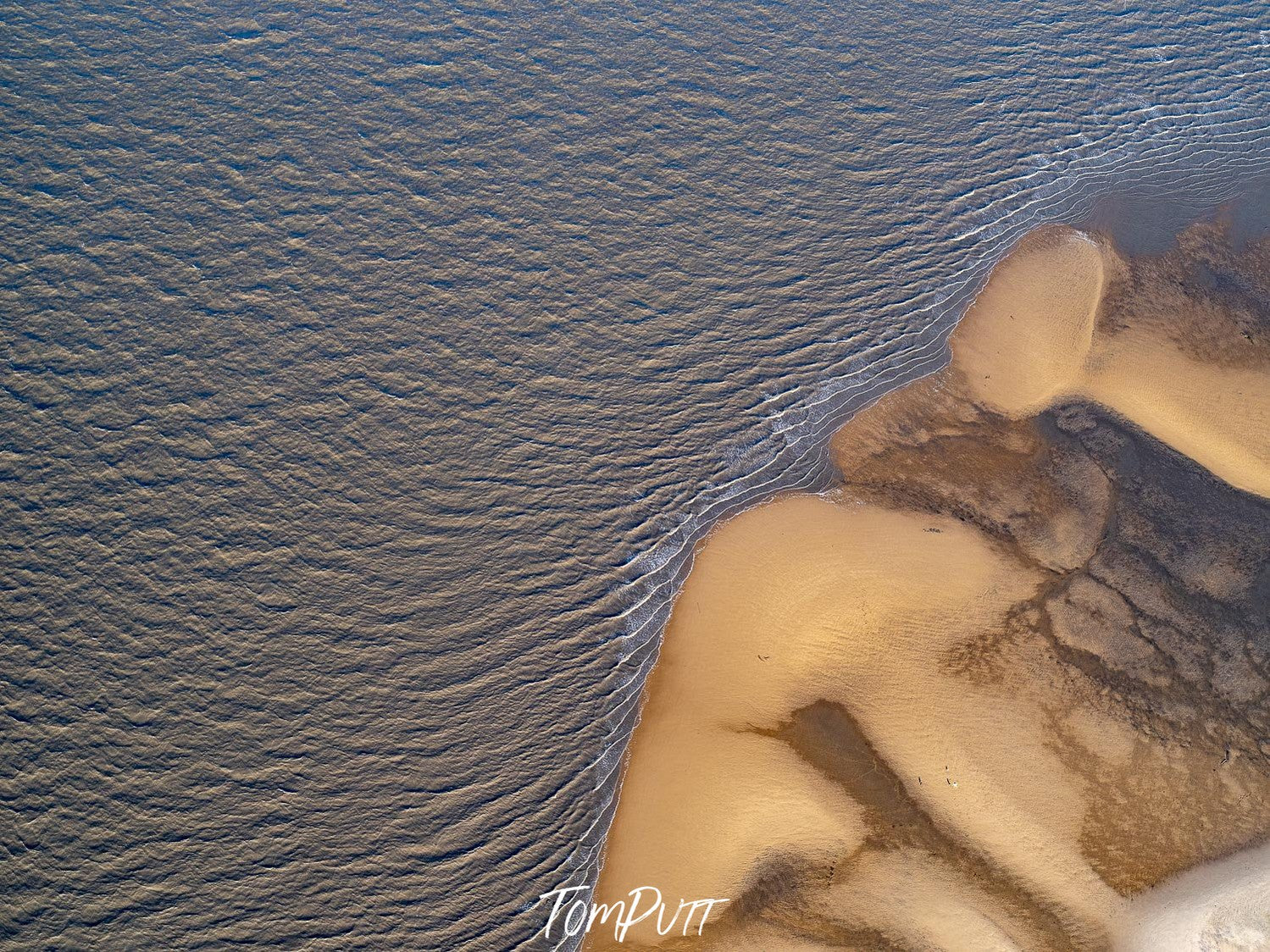 A dark sand area with uniform shape of lines, connecting with a shiny sand area with a big sand mound, French Island Aerial #5 - Western Port Bay