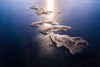 Aerial view of small sand islands in the sea with a line of sunlight effect, French Island Aerial #6 - Western Port Bay