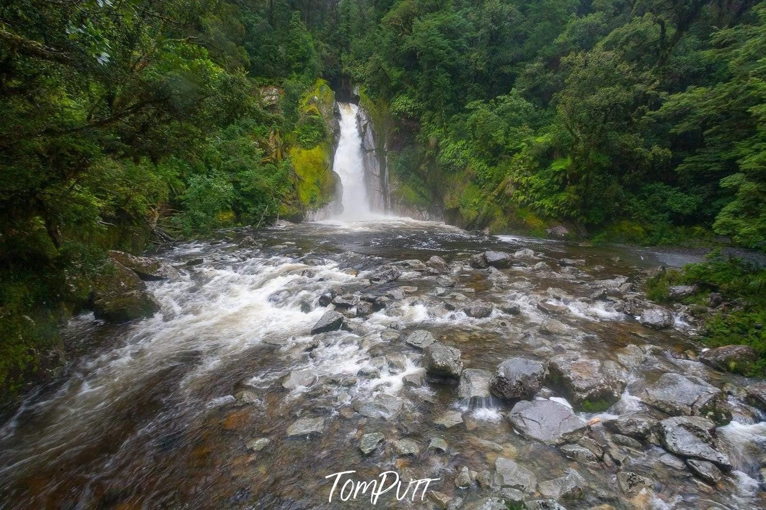 A small waterfall between a huge green mountain area, Giant Gate Falls, Milford Track - New Zealand