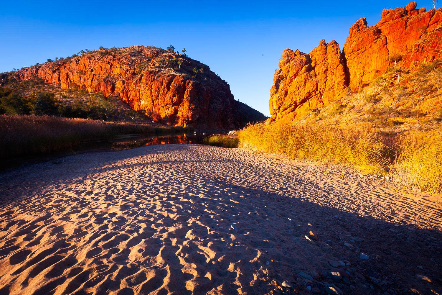 A desert pathway between two giant mountains, Glen Helen Gorge, West MacDonnell Ranges - Northern Territory