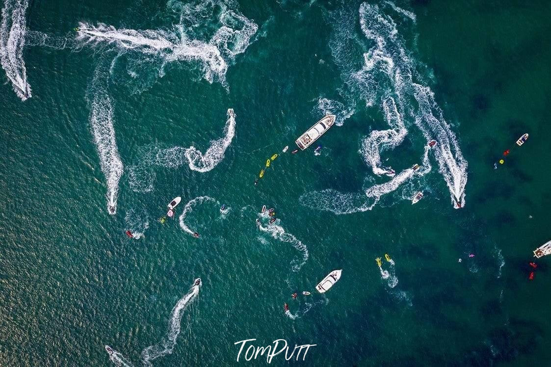 Aerial view of an ocean with many boats running in a rounded shape, Going Mad, The Pillars - Mornington Peninsula VIC