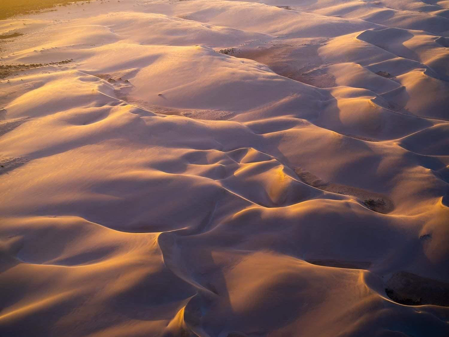 Aerial view of a desert with many waves and small mounds of sand, Golden Sands