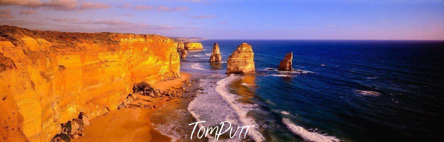 A long mountain wall with a golden effect and a seashore around, Golden Treasures - Great Ocean Road VIC