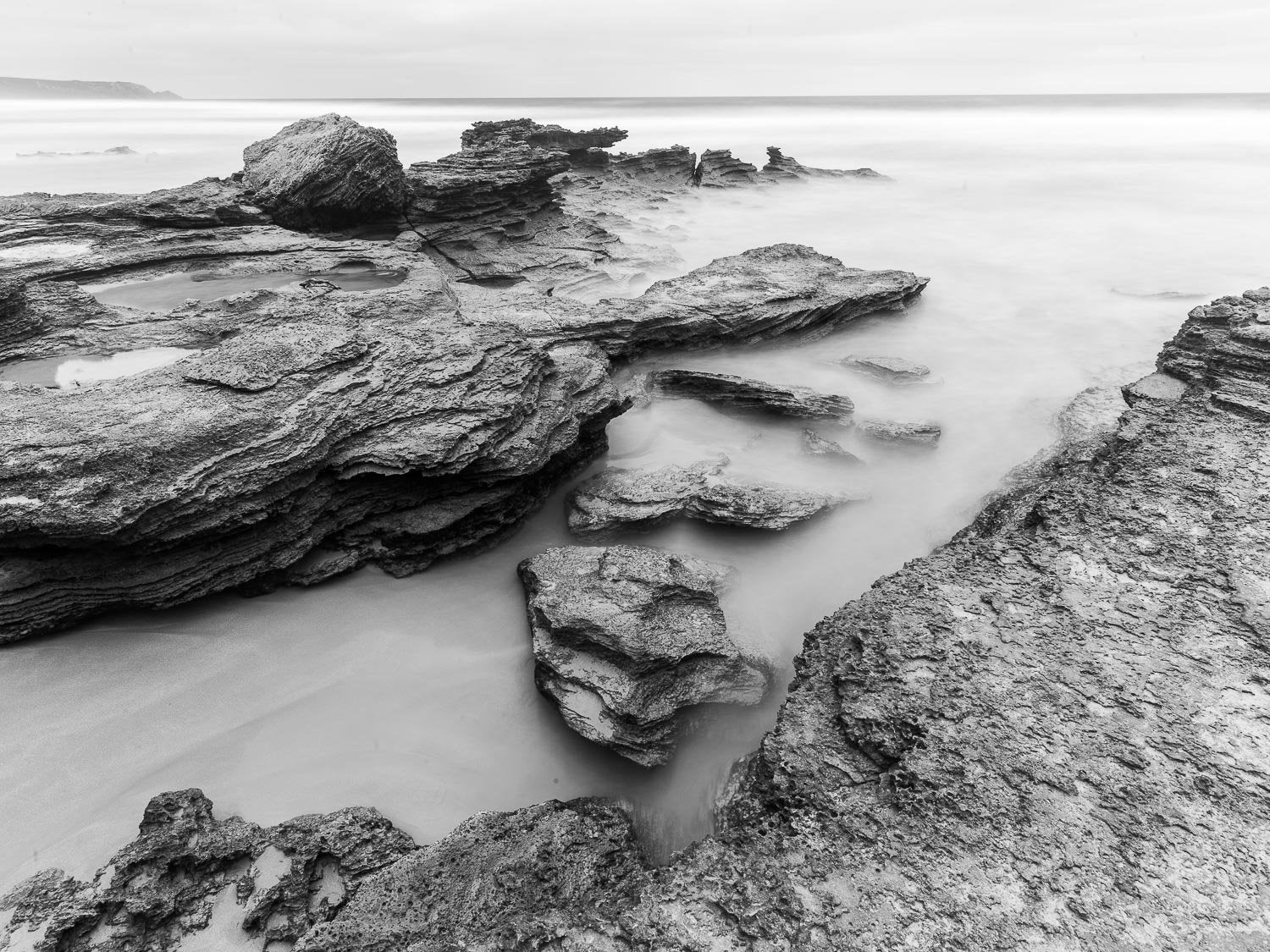 A dark view of big broken stones on a beach, Gunnamatta Rocks - Mornington Peninsula VIC