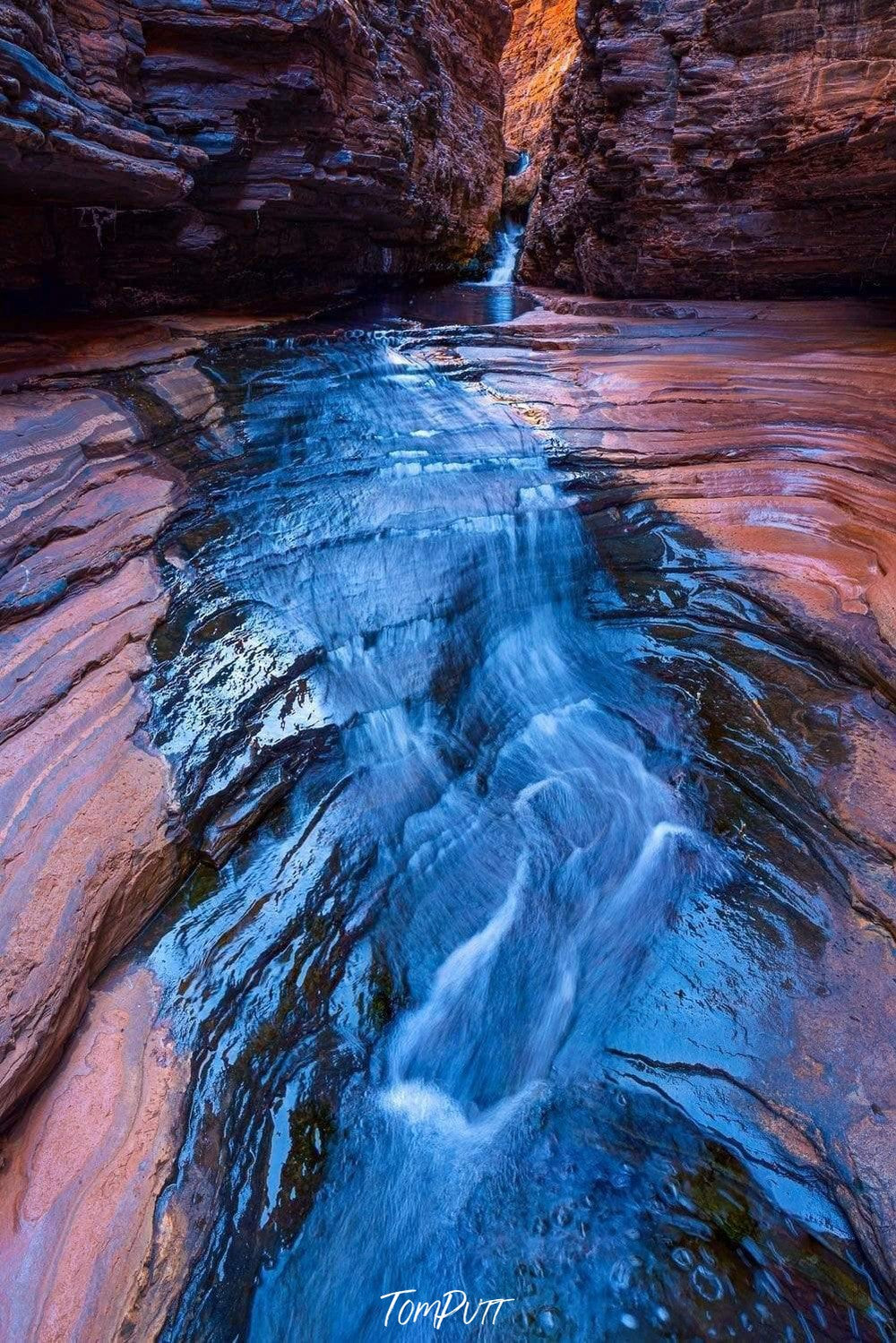 Crystal blue water course over a flat stone land, Hancock Flow - Karijini, The Pilbara