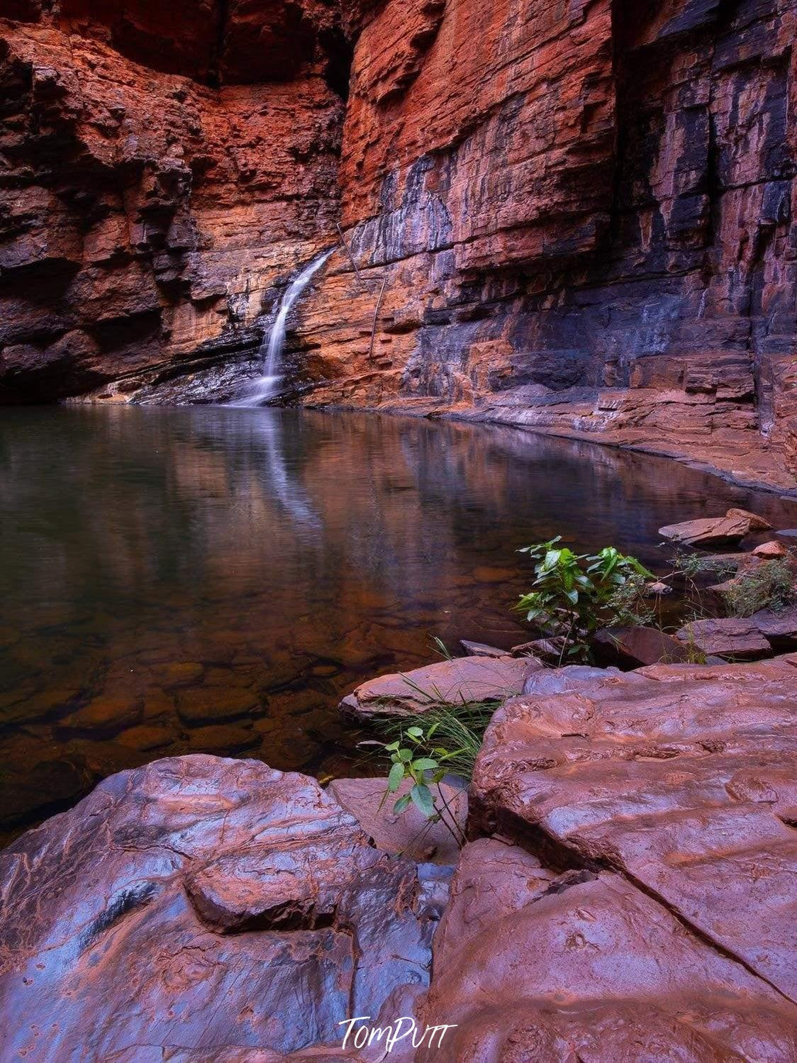 A small lake surrounded by mountain walls and stones, Handrail Tranquility - Karijini, The Pilbara