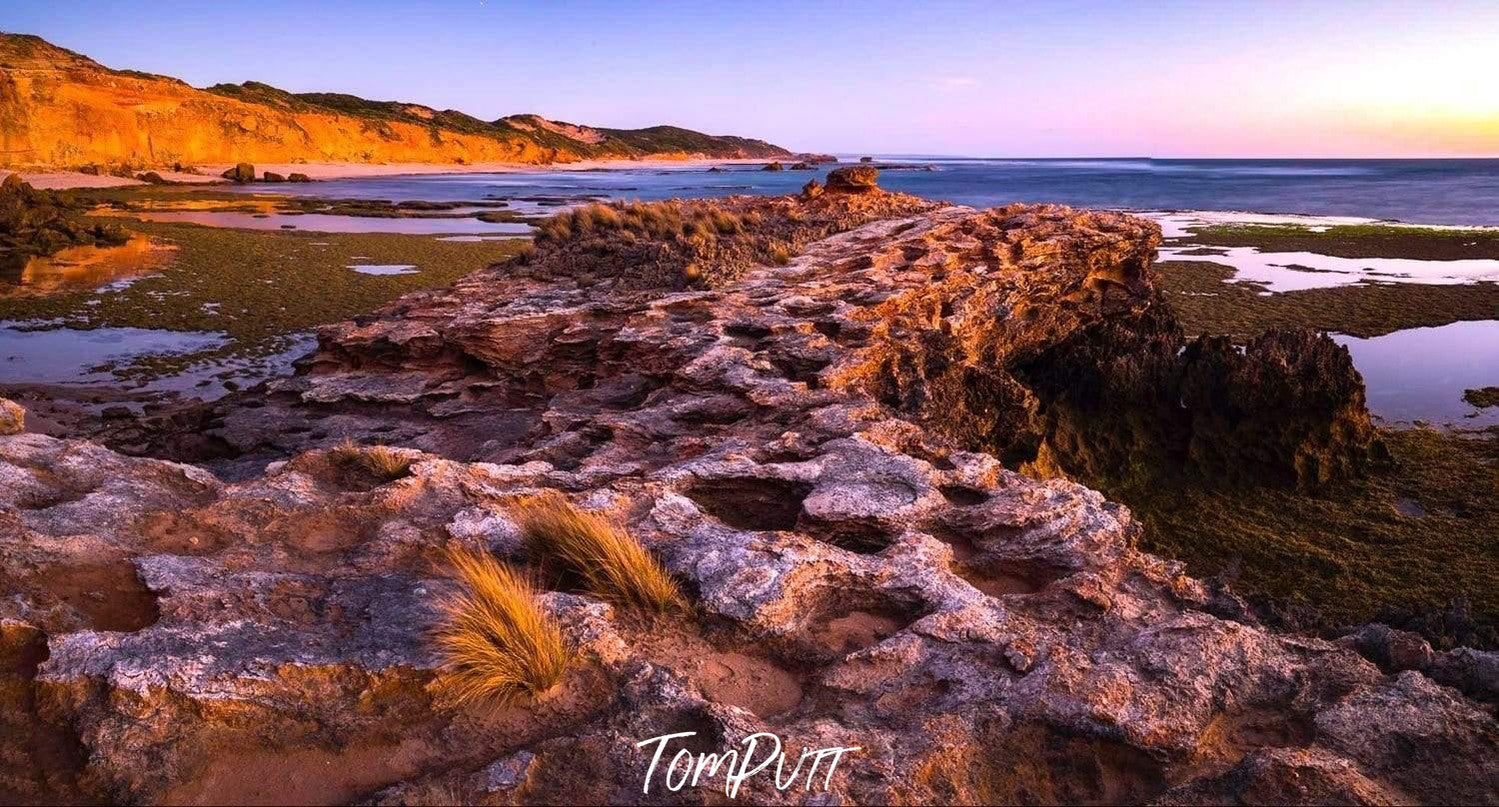 A stony land with different shapes of stones and along mountain wall in the background, Hidden Coast, Pt Nepean - Mornington Peninsula VIC 