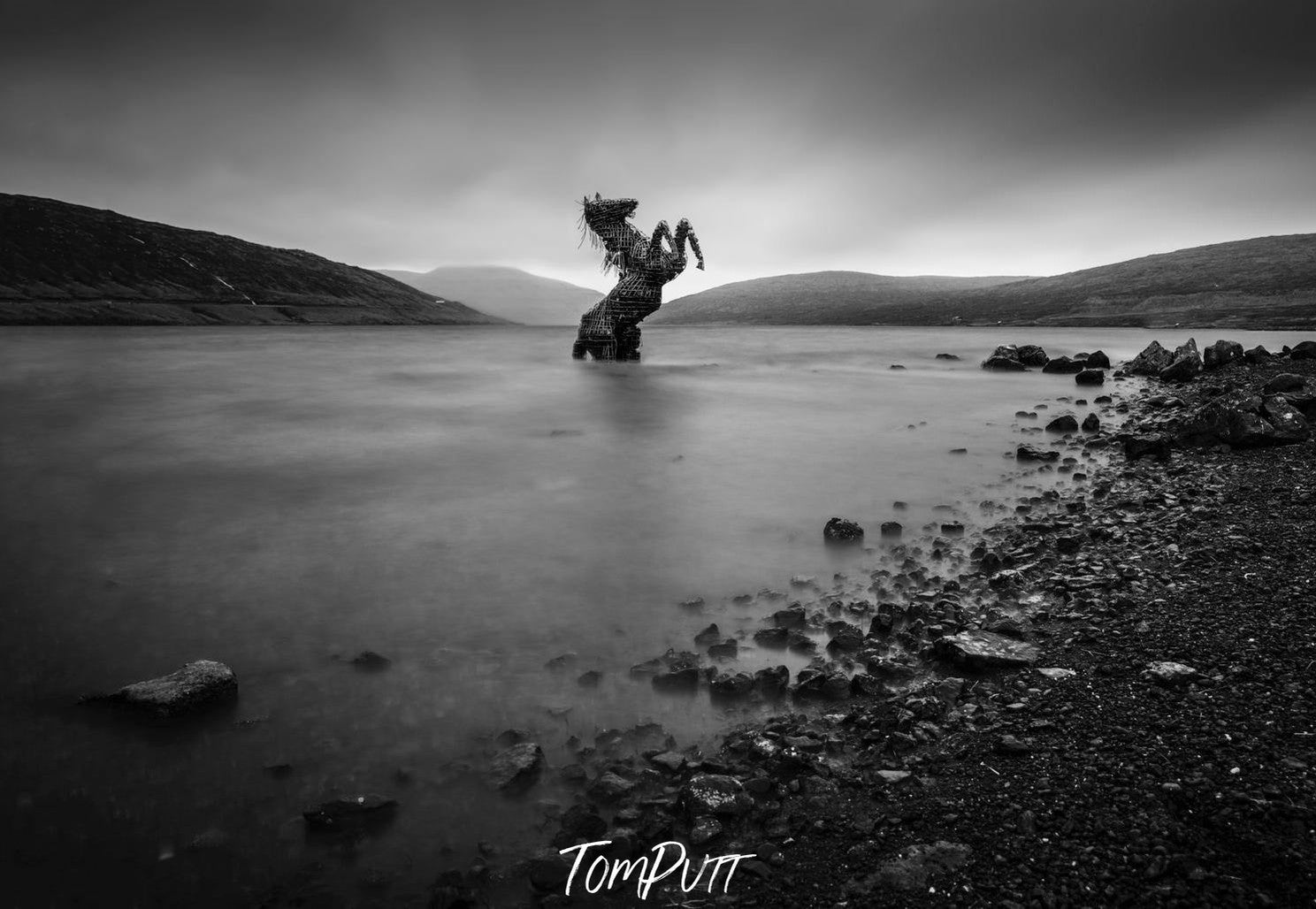 A dark horse sculpturein the water, Horse Sculpture, Faroe Islands