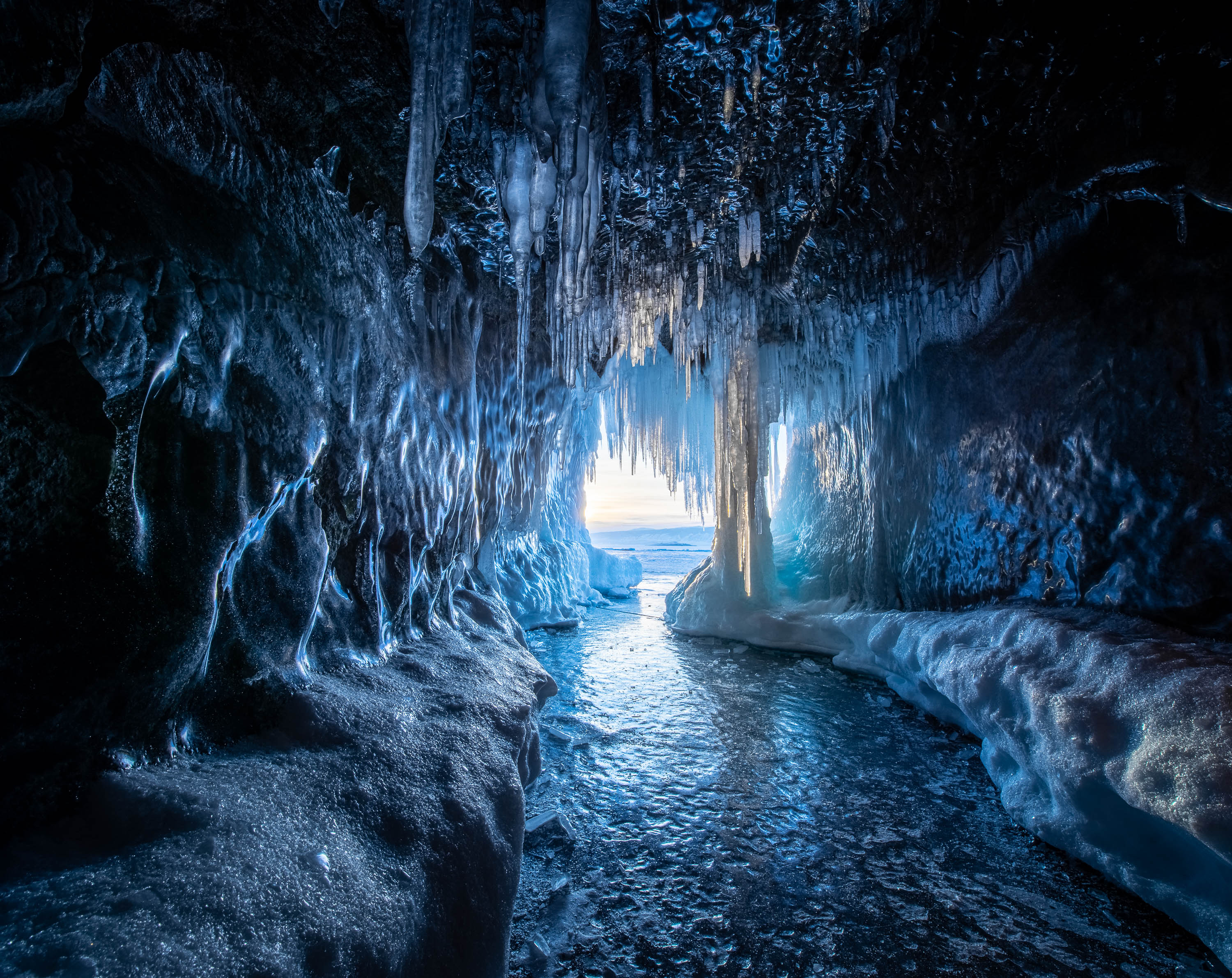 Cold tunnel pathway with crystal ice and cold water flow, Ice Cave, Lake Baikal, Siberia, Russia