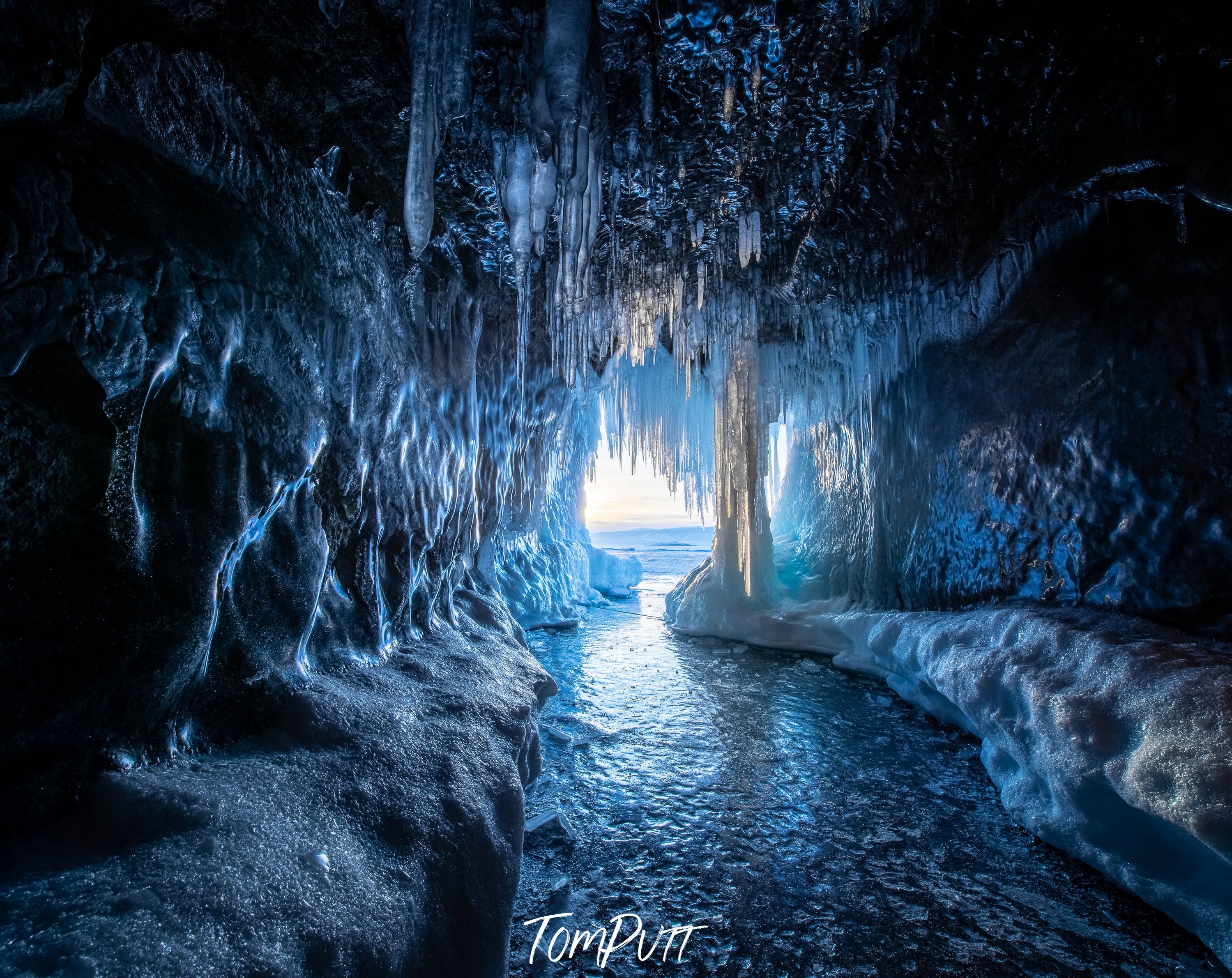 Cold tunnel pathway with crystal ice and cold water flow, Ice Cave, Lake Baikal, Siberia, Russia