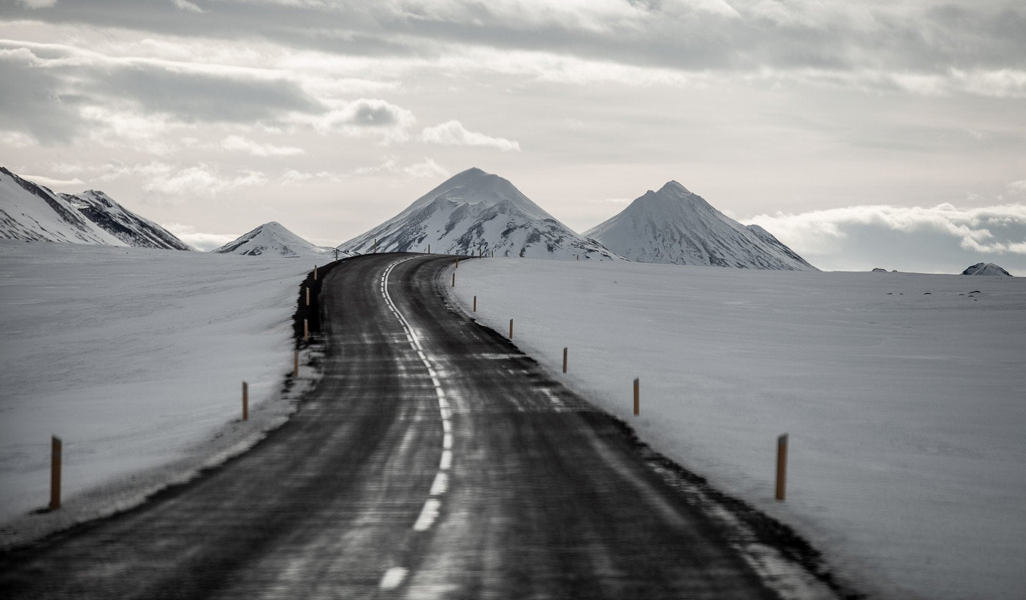 A road following mountains between a snow-covered area, Iceland #15