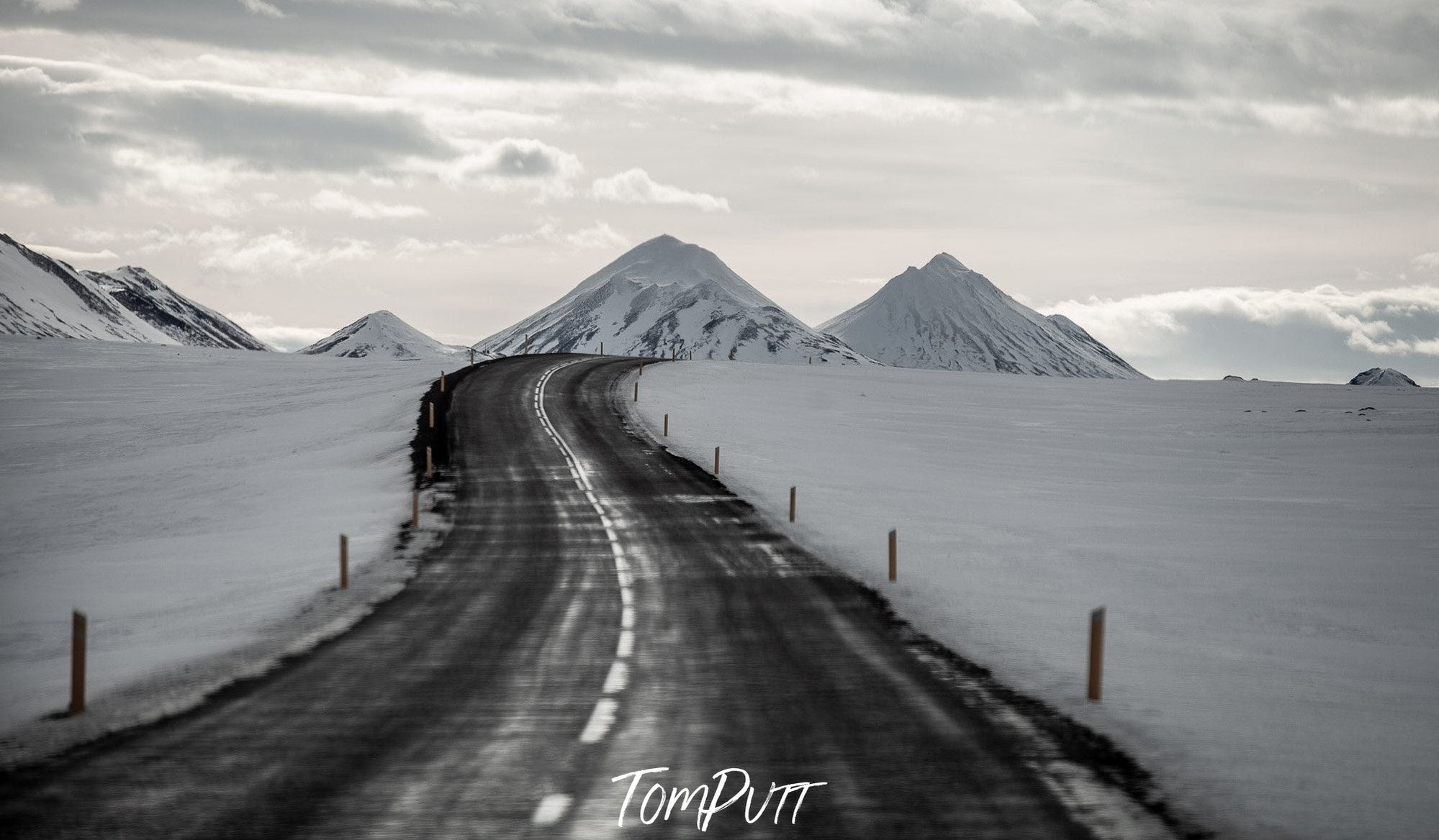 A road following mountains between a snow-covered area, Iceland #15