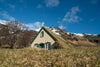 A small house in a dim green agriculture field area, Iceland #20