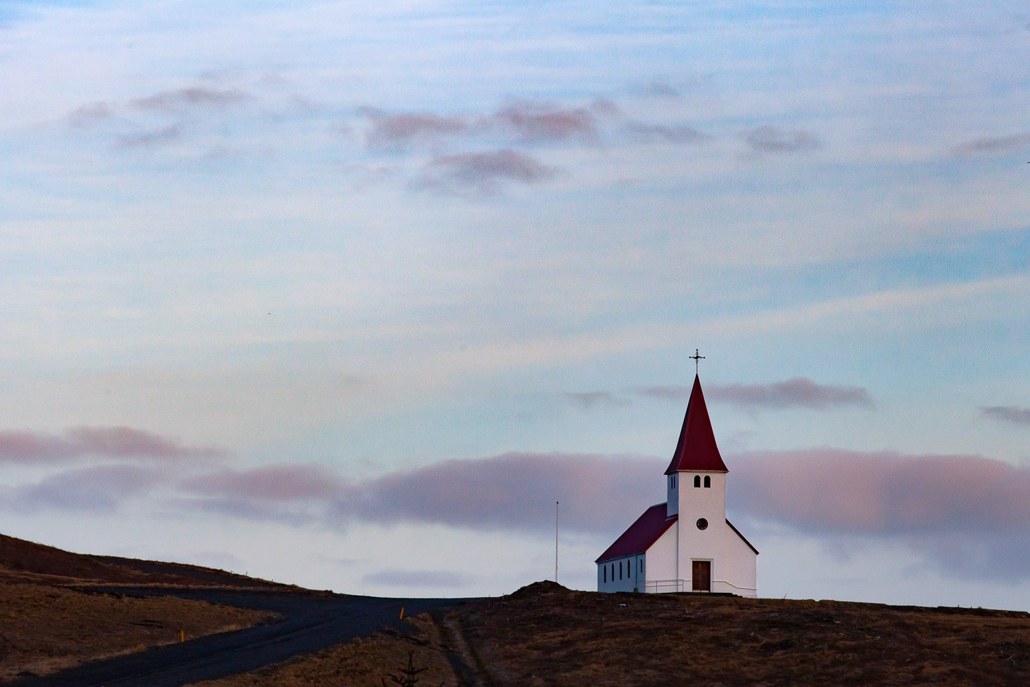 A beautiful tower long away on a greeny mountain peak, Iceland #26