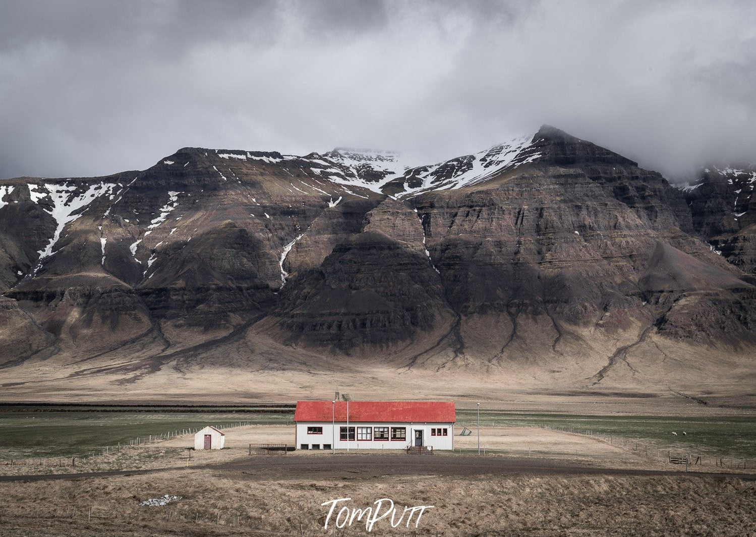 A small house in a mountain area, and some huge mountains in the background, Iceland No.5