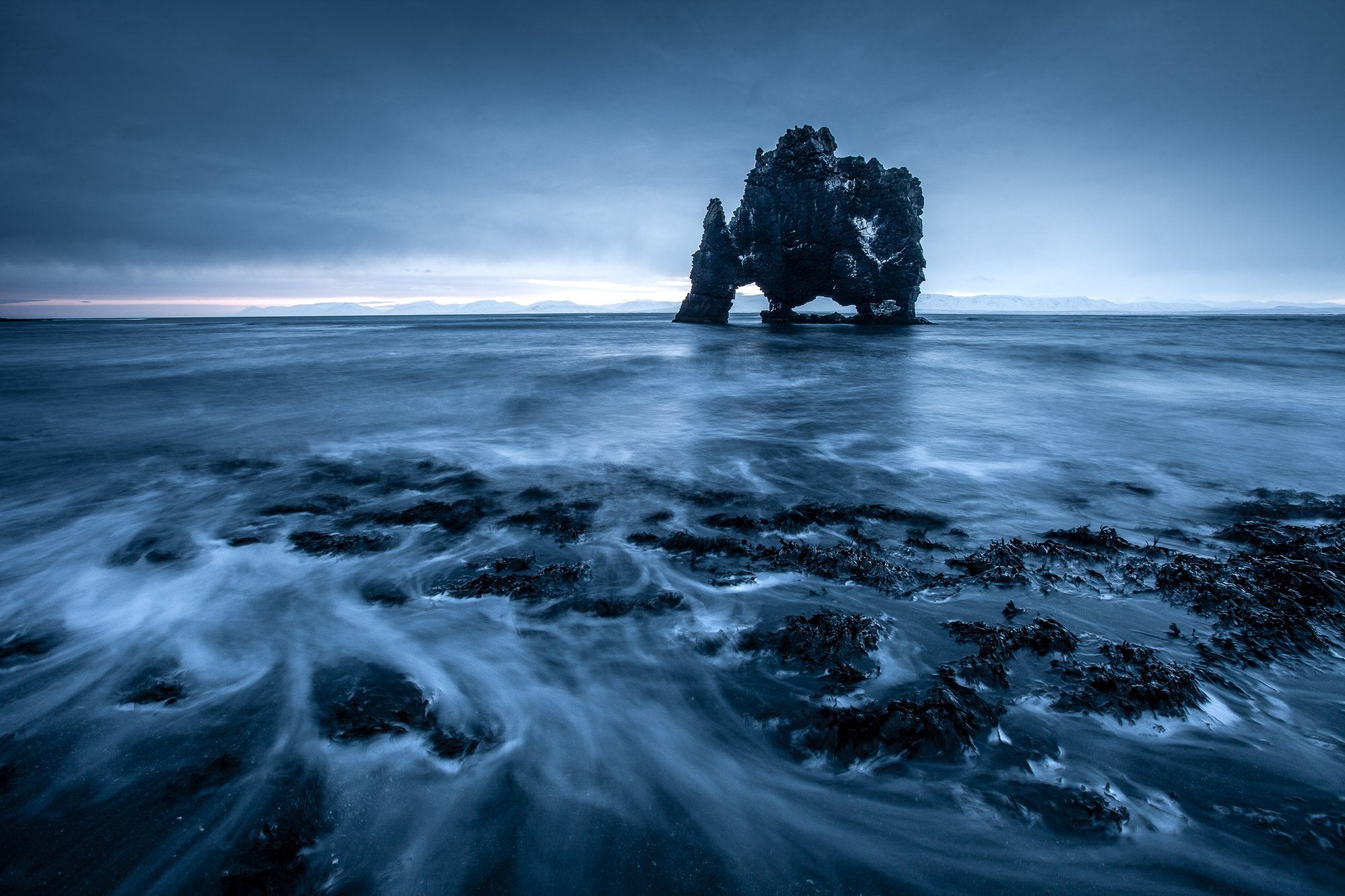 A large dark black standing stone in the sea, Iceland #9