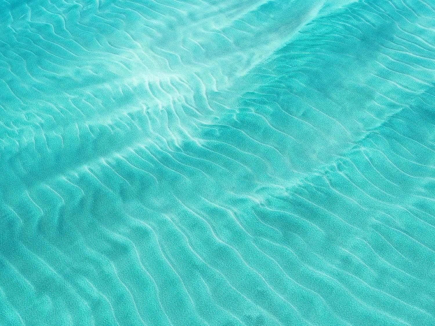Aerial view of a wavy ice-blue ocean, Inviting