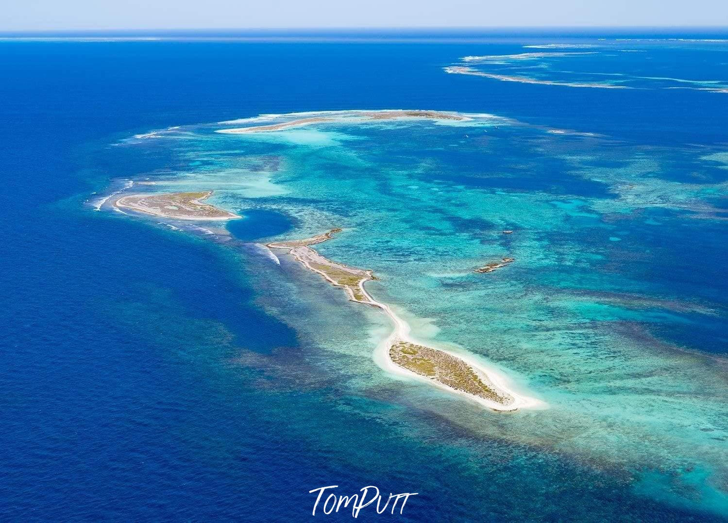 A large green area over a dark blue ocean, Island Paradise Houtman Abrolhos