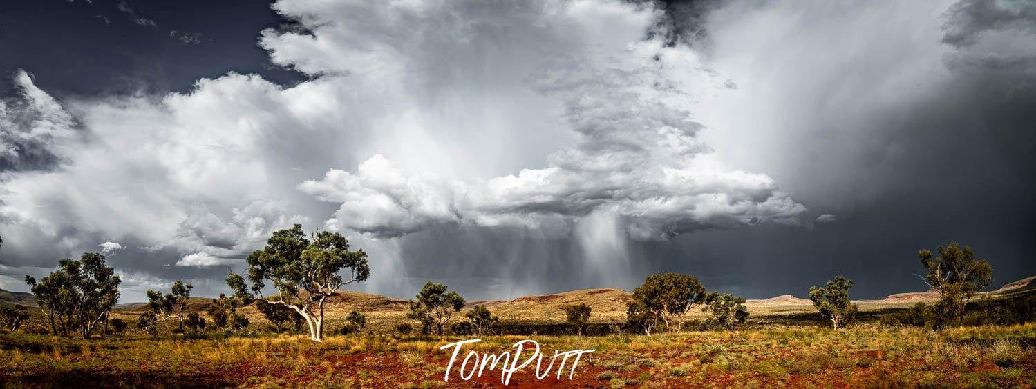 A large stony land area with some trees and a large group of smoky clouds over it, Karijini Rain - Karijini, The Pilbara