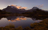 Beautiful series of mountains with a lake ahead them, a lot of greenery in the foreground, Key Summit reflection at sunset, Routeburn Track - New Zealand