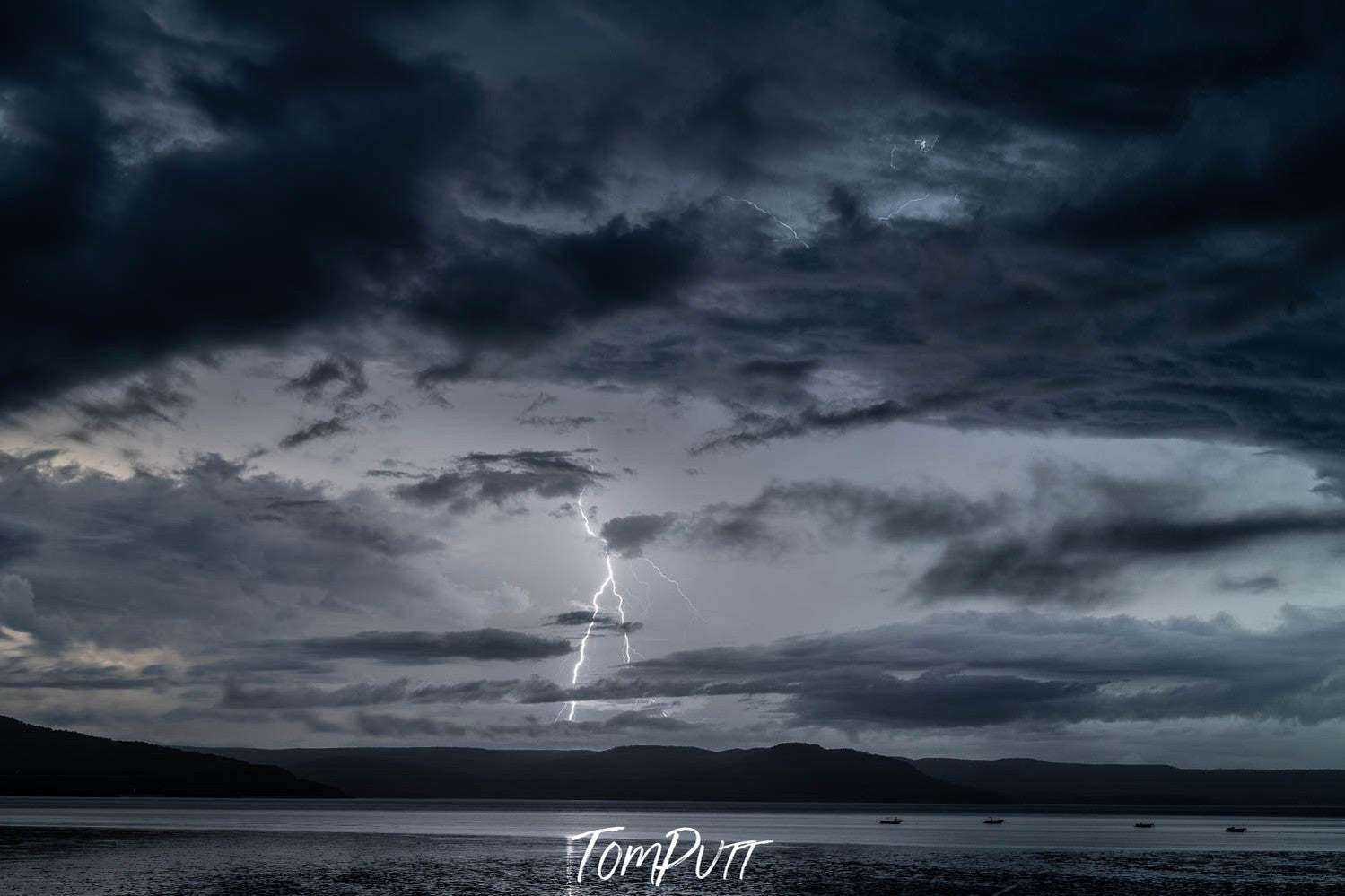 A dark view of a sea with heavy black dense clouds over it, a stormy effect of thunder and lightning, Kimberley Lightning, Western Australia