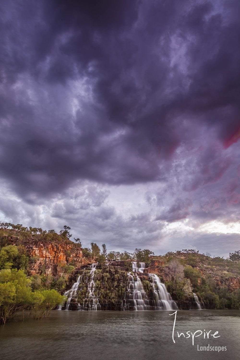A course of small waterfalls in the lack, with huge dense cloud over the scene, Kings Cascades - The Kimberley WA