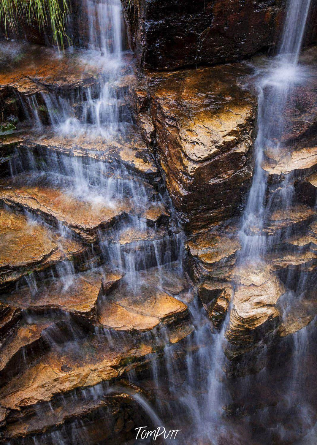 A beautiful standing mountain wall with some stairs-like steps and the passage of fresh waterfall, Cascades - The Kimberley WA 