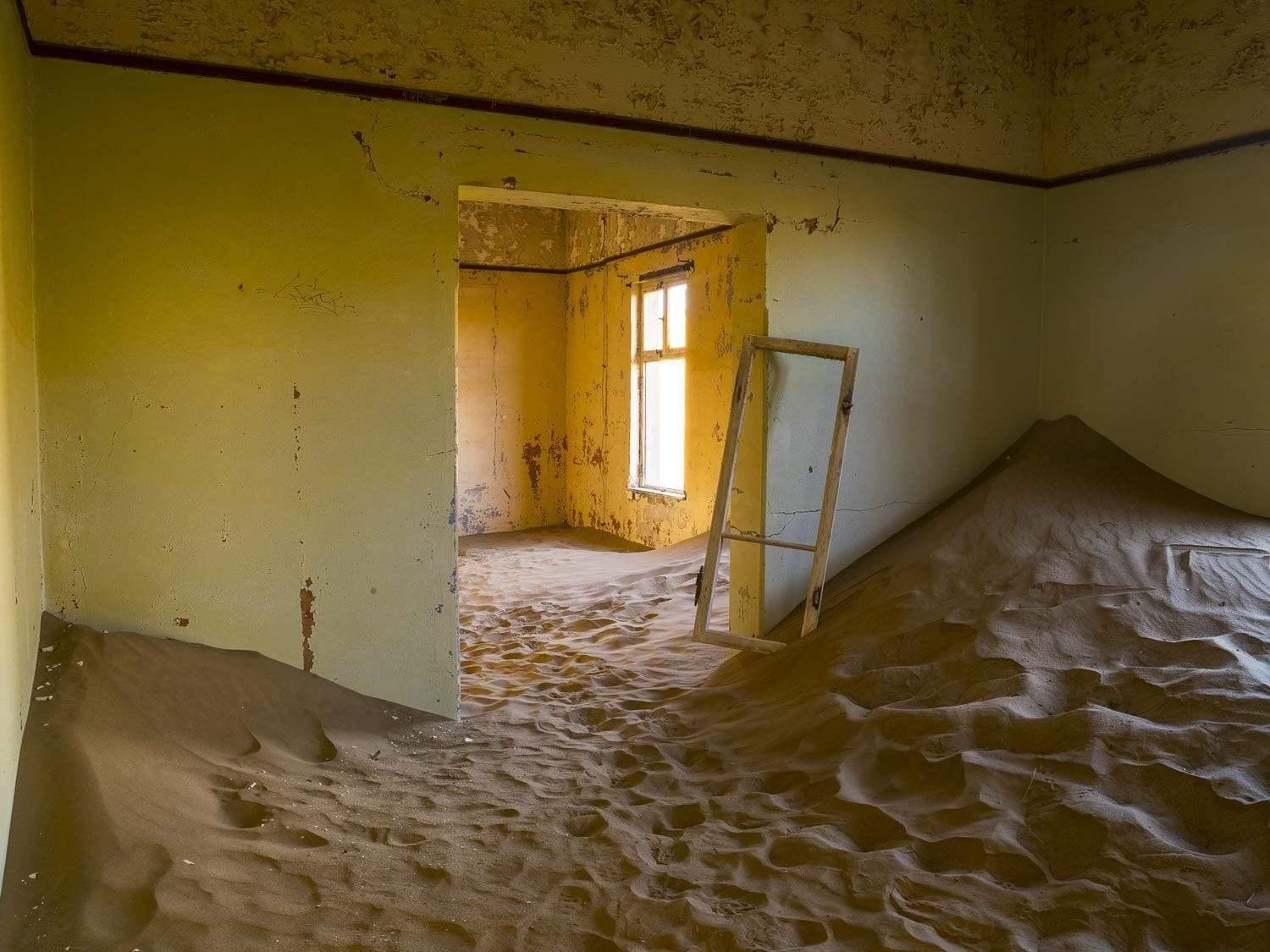 Making of a house with a mound of sand inside the room, Kolmanskop #11