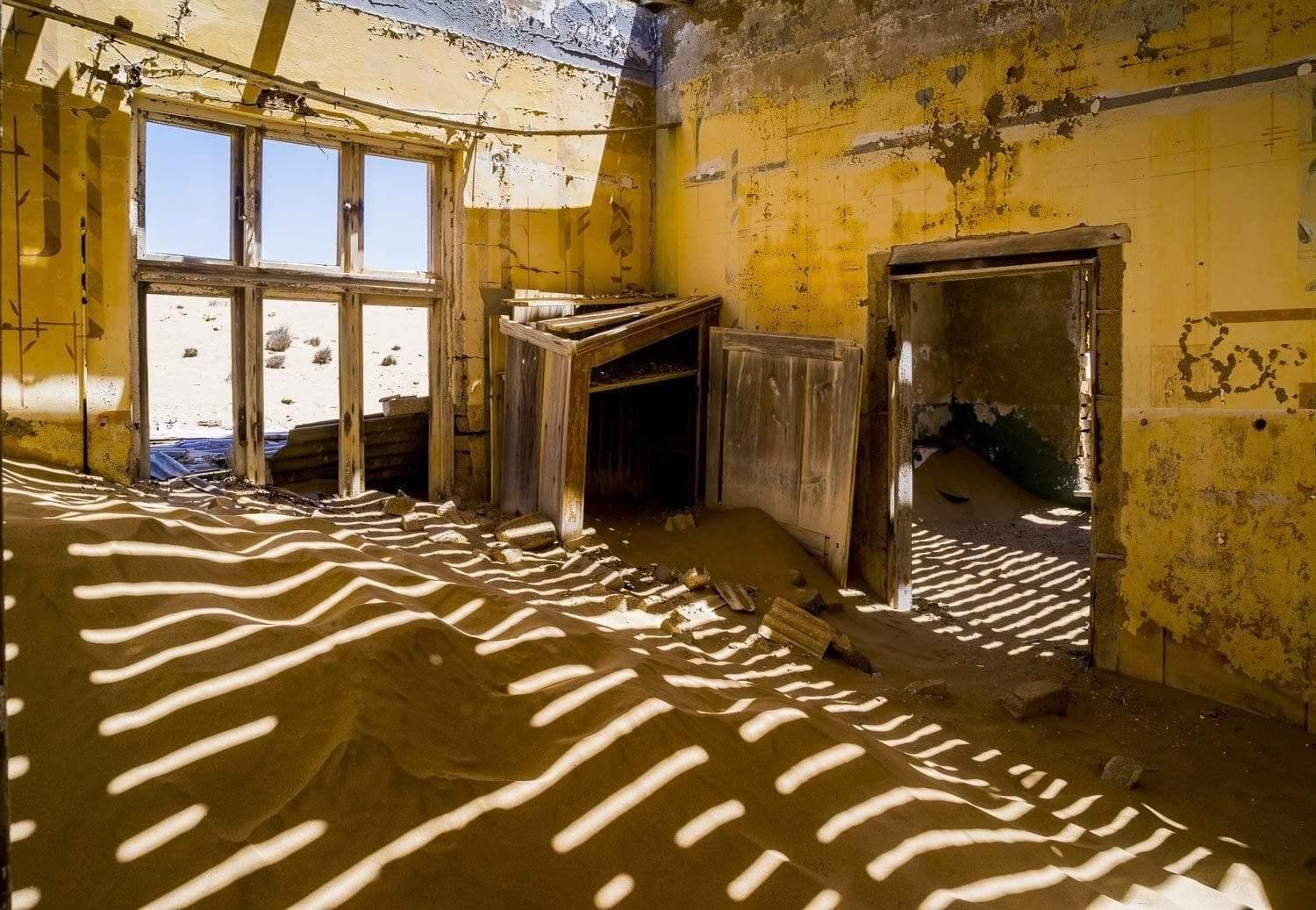 Making of a house with a lot of construction sand inside, with sunlight coming, Kolmanskop #2