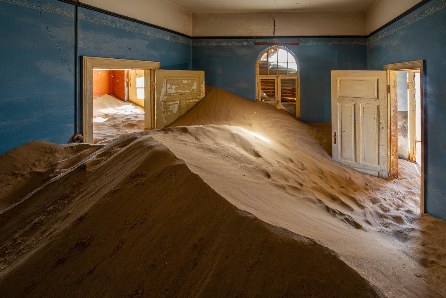 Making of a house room with a lot of construction sand inside, Kolmanskop #26