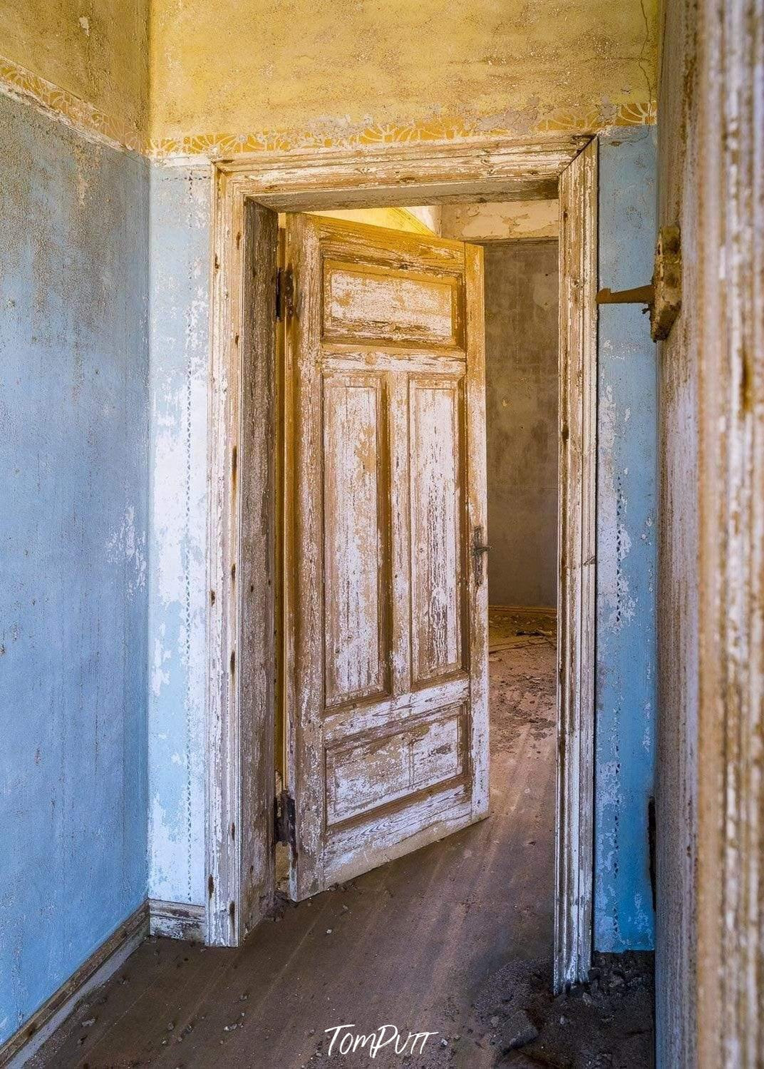 An old house's corridor with open room doors, Kolmanskop No.31