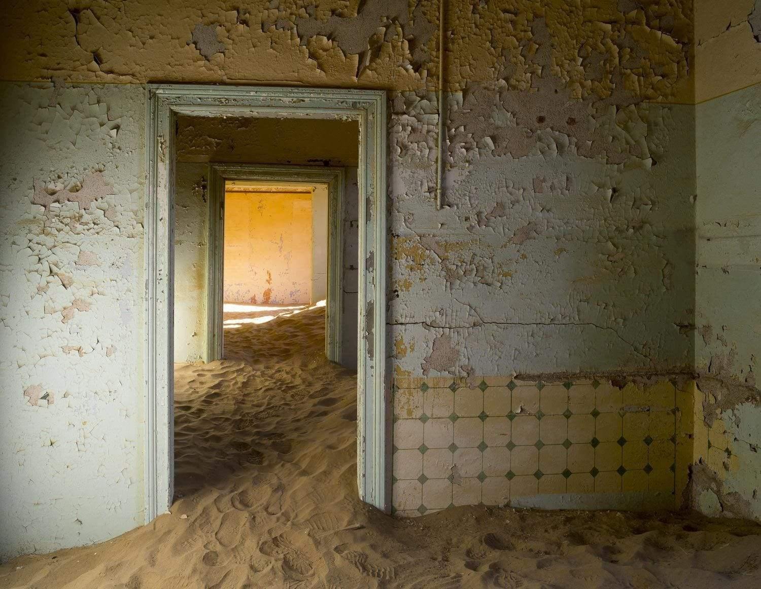 Making of a house with an open door of room, some construction sand inside, Kolmanskop #6
