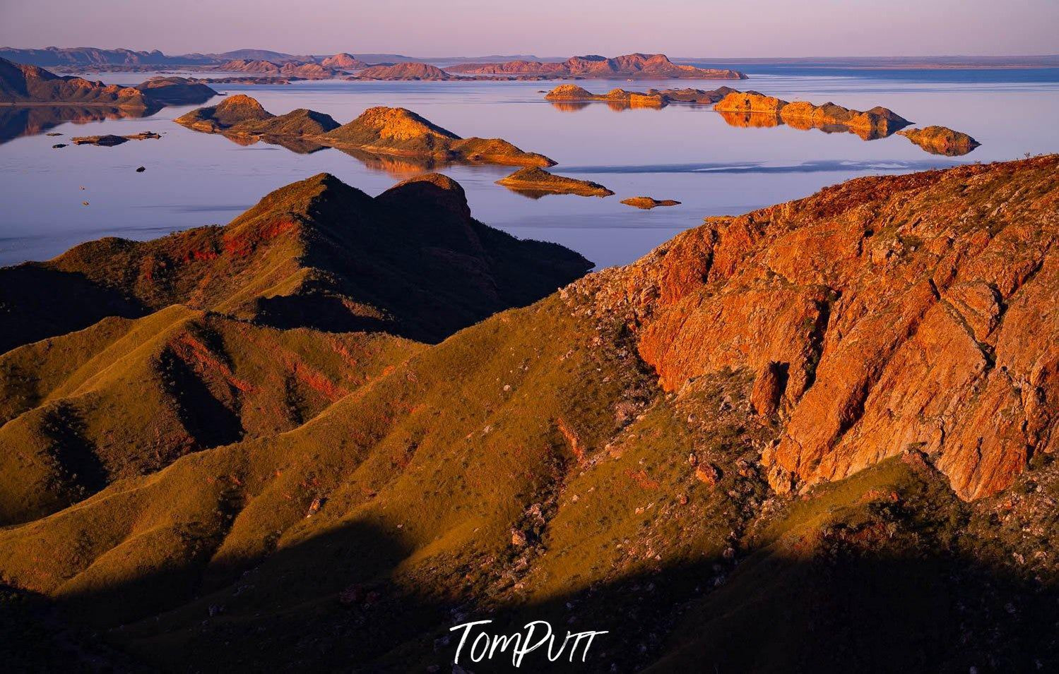 A giant couple of mountains with some greenery over them, and a lake in the background, Lake Argyle #4 - The Kimberley