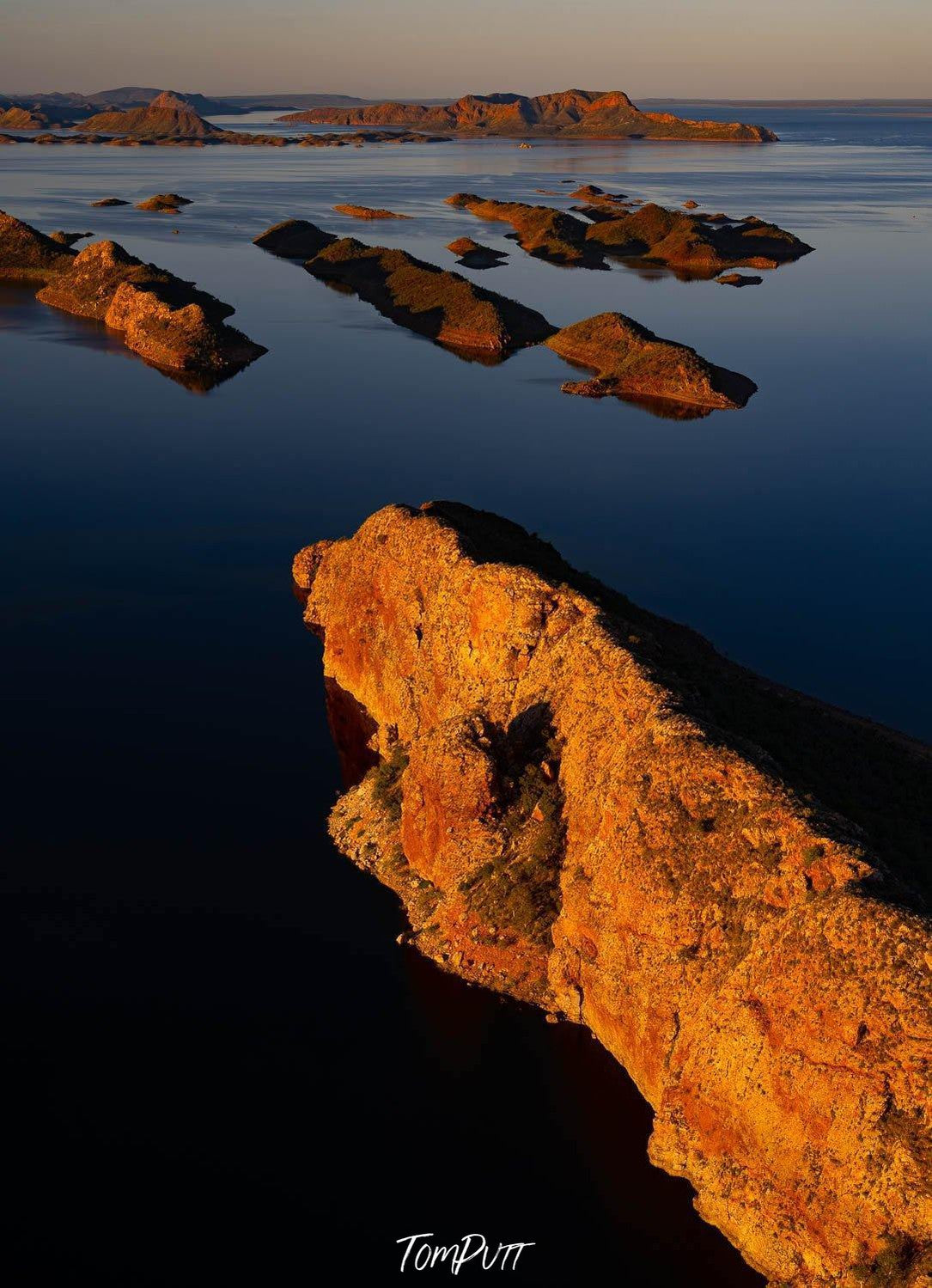 Giant mountains standing in the lake, with a burst of sunshine falling, Lake Argyle #8 - The Kimberley