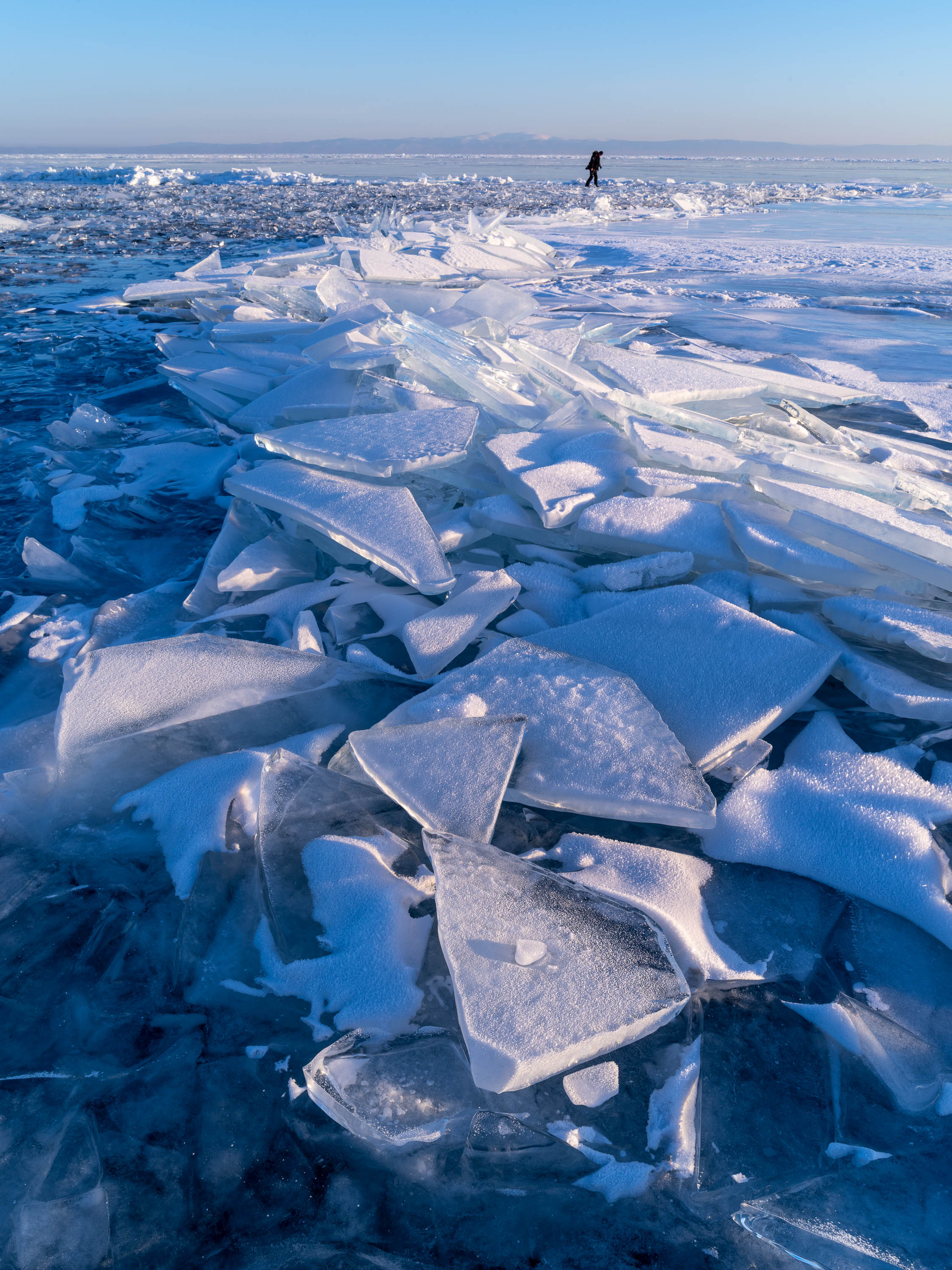 Crystalline glass-like ice pieces on a fully snow-covered land, Lake Baikal #12, Siberia, Russia