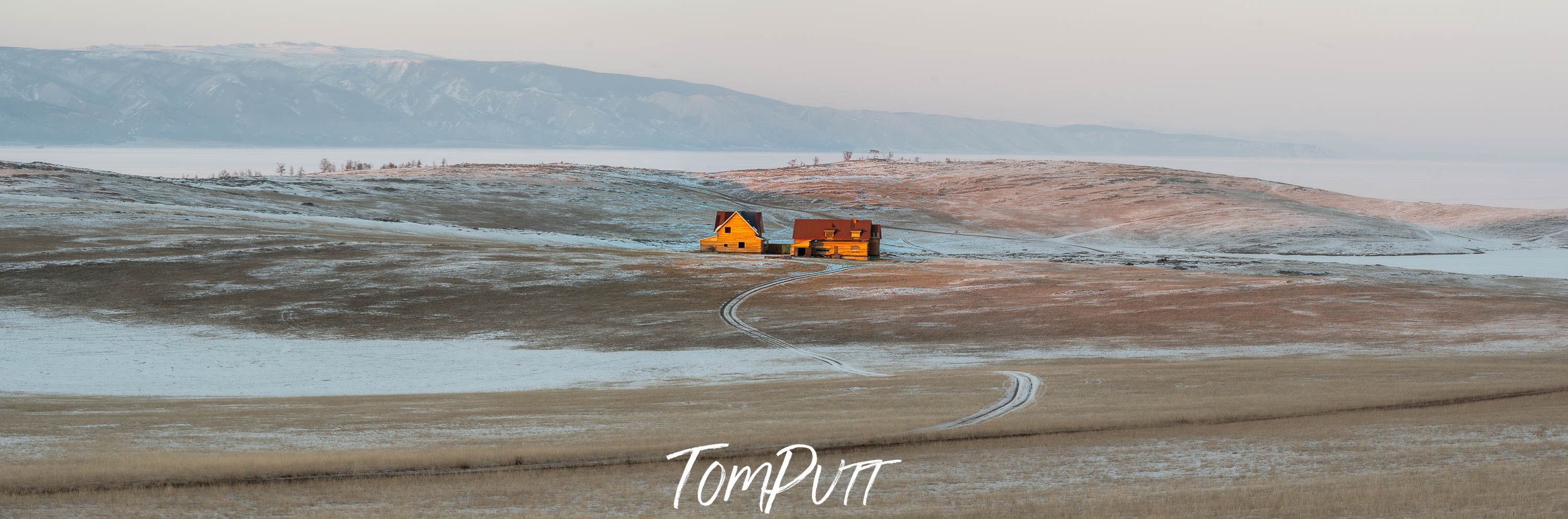 A wide seashore with some water on the shore and a couple of small huts, Lake Baikal #14, Siberia, Russia