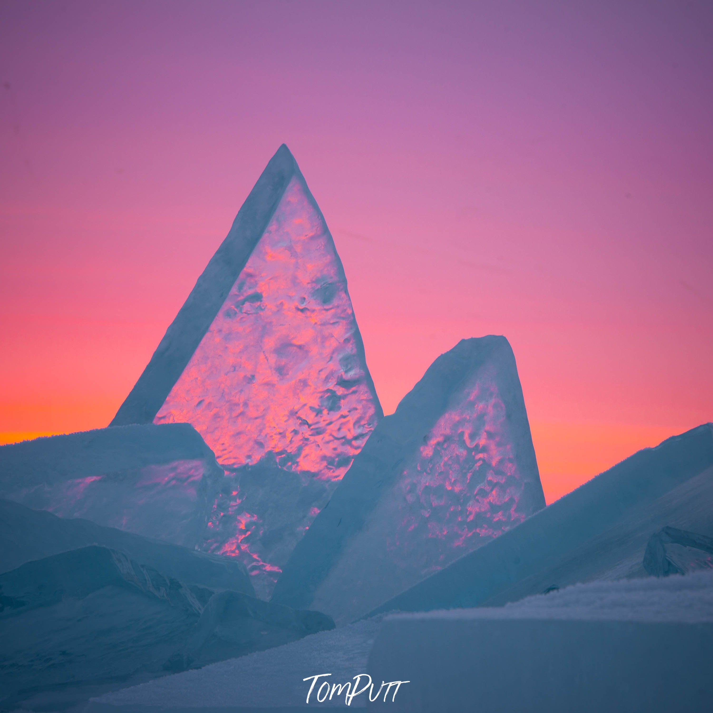 Close-up shot of crystalline sharp ice pieces penetrating in the snow ground, and a reddish weather effect, Lake Baikal #19, Siberia, Russia