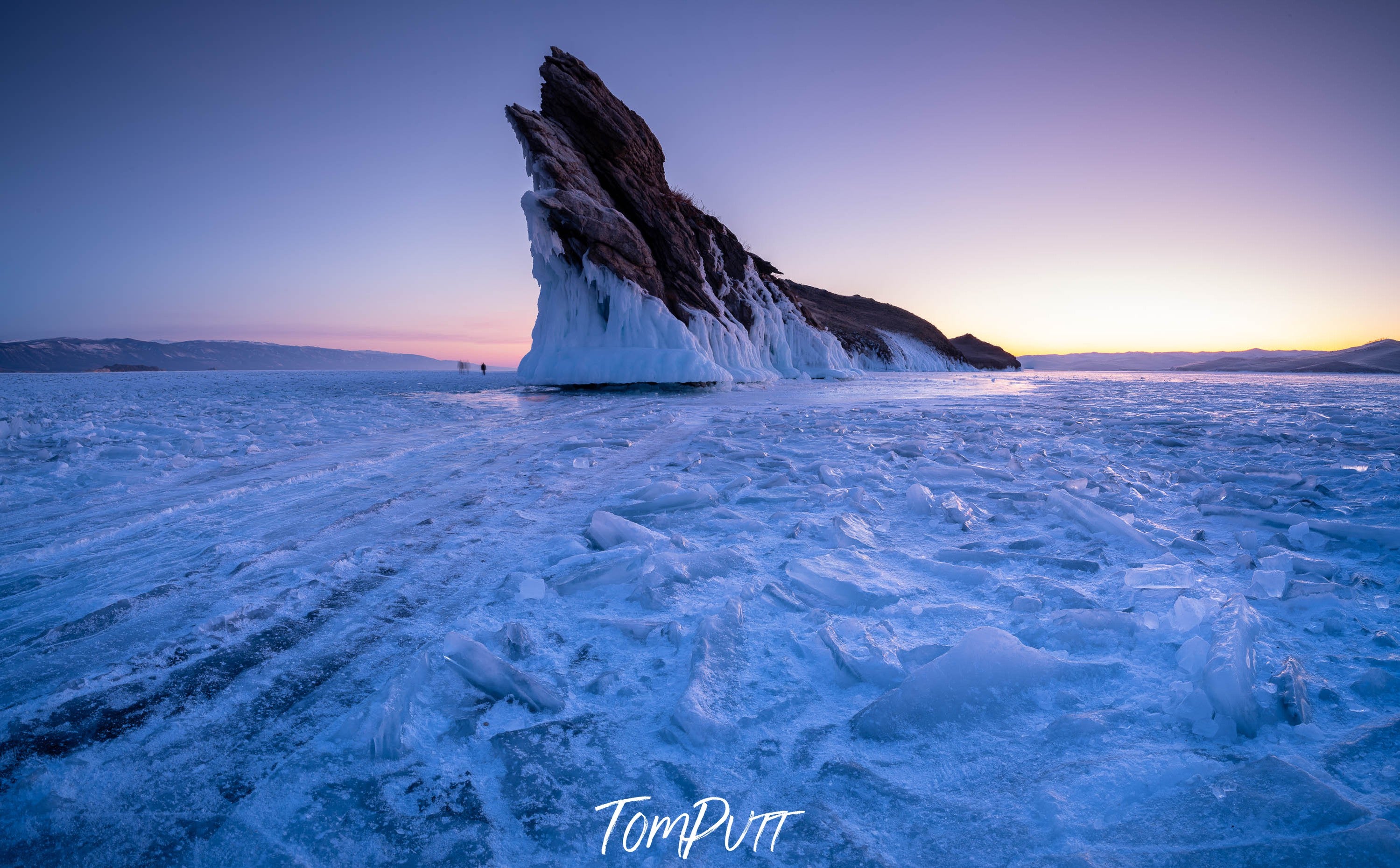 A high mountain partially covered with snow, and a snow land in the foreground, Lake Baikal #2, Siberia, Russia